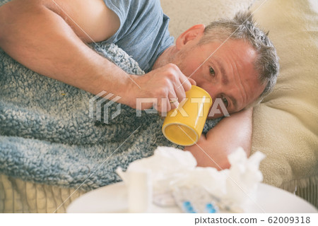 Mature man suffering from coronavirus, flu or cold Mature man suffering from coronavirus, flu or cold 62009318