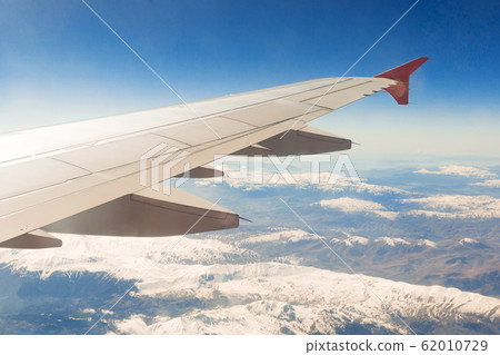 view from the window of the plane that flies over view from the window of the plane that flies over 62010729