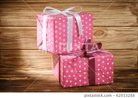 Gift box with ribbon on wooden background top view 62013288