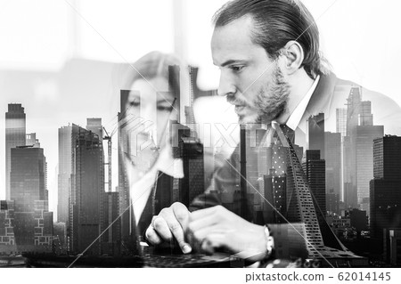 Business people in modern office against new york city manhattan buildings and skyscrapers window reflections. 62014145