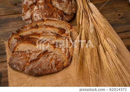 Freshly whole grain bread and bread slices on a Freshly whole grain bread and bread slices on a 62014371
