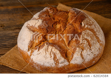 A fresh whole grain bread from the baker on a jute A fresh whole grain bread from the baker on a jute 62014384
