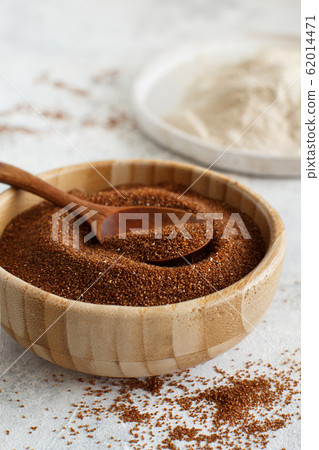 Raw teff grain in a bowl and teff flour close up 62014471