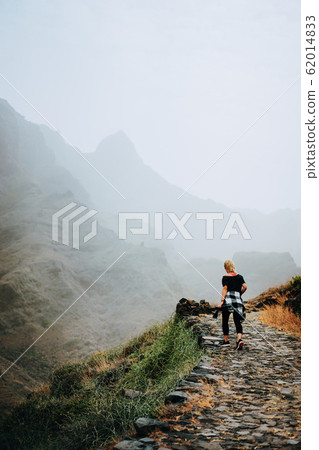 Santo Antao Island, Cape Verde. Tourist female on stony hiking path to Ponta do Sol over arid Aranhas valley 62014833