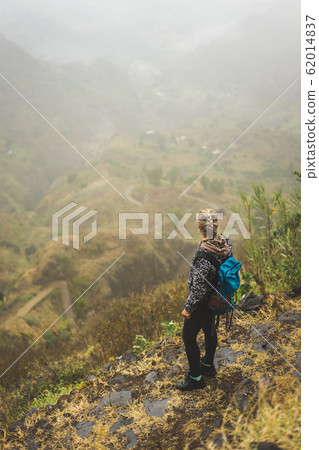Santo Antao Island Cape Verde. Female tourist with backpack enjoying hiking path route to Paul valley Santo Antao Island Cape Verde. Female tourist with backpack enjoying hiking path route to Paul valley 62014837