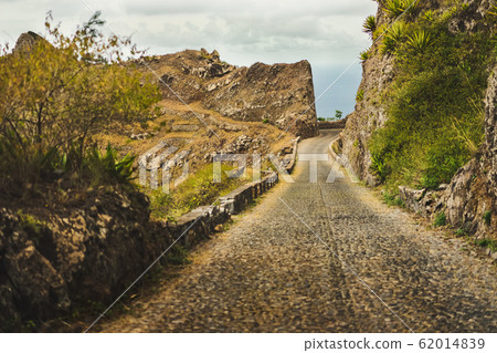 Santo Antao island, Cape Verde. Narrow mountain road on Delgadinho mountain ridge leading to Ribeira Grande Santo Antao island, Cape Verde. Narrow mountain road on Delgadinho mountain ridge leading to Ribeira Grande 62014839