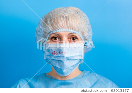 Portrait of woman wearing medical uniform and mask 62015177
