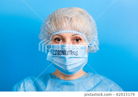 Portrait of woman in medical uniform and mask with 62015179