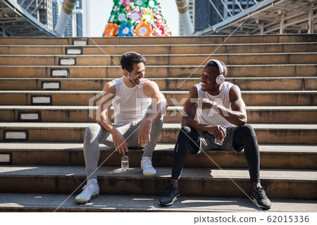 American friends rest and talk after exercise American friends rest and talk after exercise 62015336