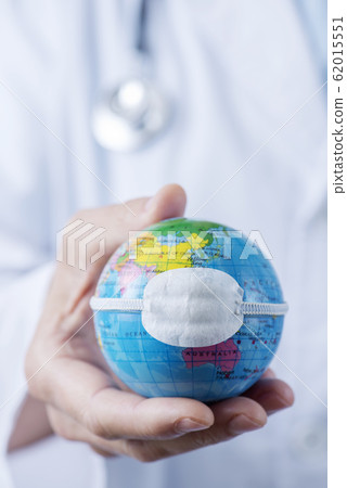 doctor man showing a globe with a mask doctor man showing a globe with a mask 62015551