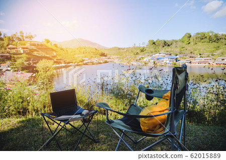 Adventures Camping and And use a working notebook near lake, Concept Travel 62015889