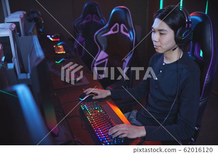 Asian Man Playing Video Games in Computer Club 62016120