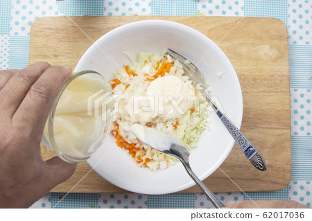 Chef putting cream salad to the bowl for cooking Chef putting cream salad to the bowl for cooking 62017036