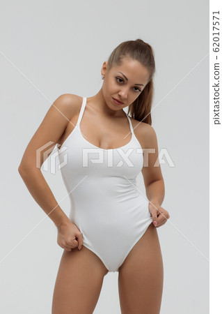 Crop gorgeous woman taking off swimsuit 62017571