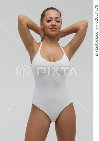 Crop gorgeous woman taking off swimsuit Crop gorgeous woman taking off swimsuit 62017579