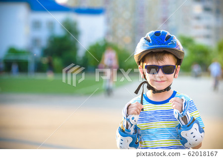 Little boy riding on rollers in the summer in the Little boy riding on rollers in the summer in the 62018167