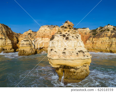 Rock cliffs and waves in Algarve Rock cliffs and waves in Algarve 62018559