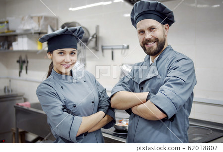 Two smiling crossed arms cooks Two smiling crossed arms cooks 62018802