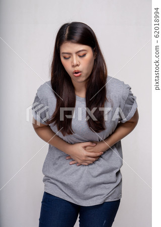 Young asian Woman stomachache over gray background 62018994