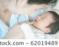Closeup mother gently played with the child while sleeping 62019489