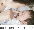 Closeup mother gently played with the child while sleeping 62019492