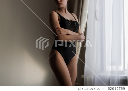 Attractive sensual woman in lingerie in room Attractive sensual woman in lingerie in room 62019769