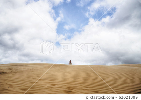 Lighthouse buried in a large sand dune 62021399