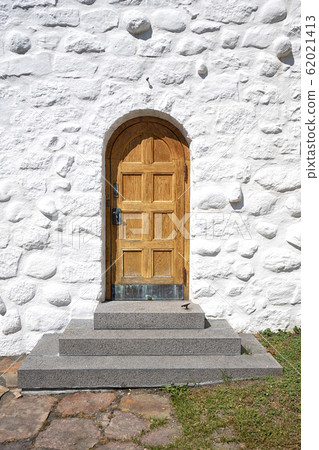 Wooden door with a stairway on an old building Wooden door with a stairway on an old building 62021413