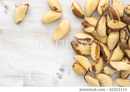 Scattered brazil nuts on wooden table, stock Scattered brazil nuts on wooden table, stock 62023114
