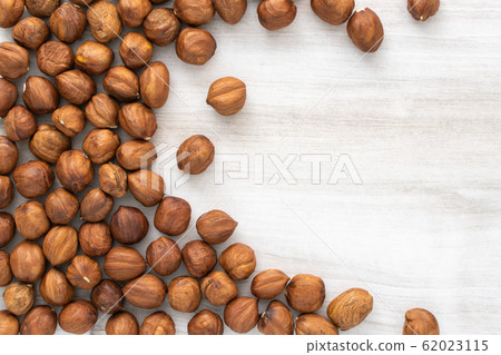 Scattered hazlenuts on wooden table, stock photo. Scattered hazlenuts on wooden table, stock photo. 62023115