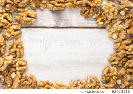 Scattered walnuts on wooden table, stock photo. Scattered walnuts on wooden table, stock photo. 62023116