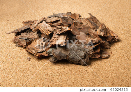 Heap of Pine Tree Bark Chip on Brown Cork Board Heap of Pine Tree Bark Chip on Brown Cork Board 62024213
