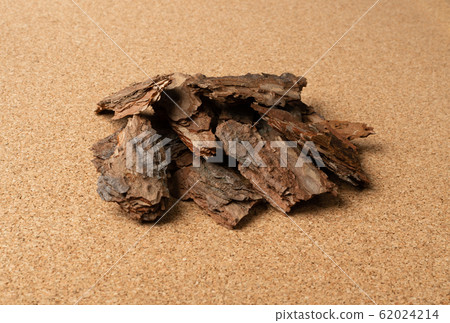 Heap of Pine Tree Bark Chip on Brown Cork Board Heap of Pine Tree Bark Chip on Brown Cork Board 62024214