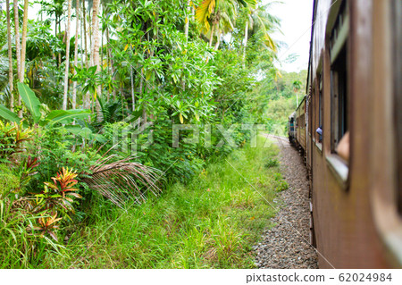 Train ride in Sri Lanka. Man hanging on a wagon Train ride in Sri Lanka. Man hanging on a wagon 62024984