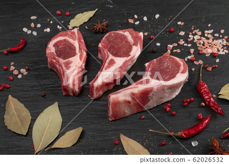 Raw Lamb Chops, Mutton Cuts or Sheep Ribs on Black Raw Lamb Chops, Mutton Cuts or Sheep Ribs on Black 62026532