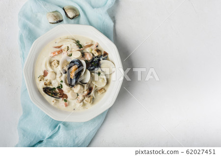 Clam chowder in a white plate. The main 62027451