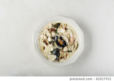 Clam chowder in a white plate. The main 62027452