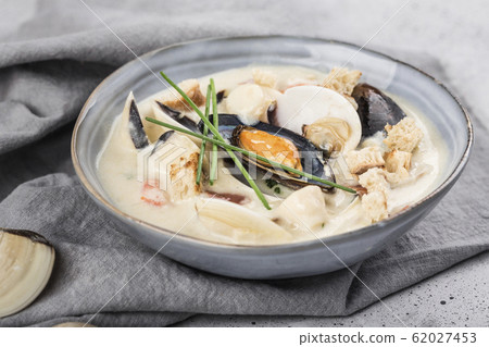 Clam chowder in a gray plate. The main ingredients 62027453