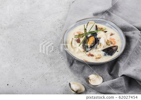 Clam chowder in a gray plate. The main ingredients 62027454