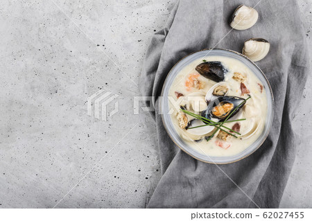Clam chowder in a gray plate. The main ingredients 62027455