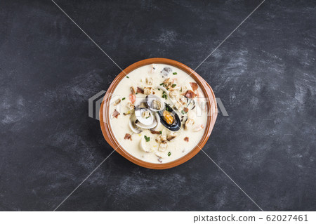 Clam chowder in a brown plate. The main Clam chowder in a brown plate. The main 62027461