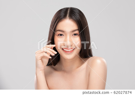 Beautiful Asian young woman touching soft cheek smile with clean and fresh skin Happiness and cheerful with positive emotional,isolated on white background,Beauty and Cosmetics Concept 62027874