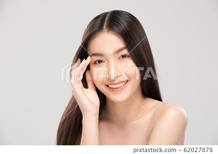 Beautiful Asian young woman touching soft cheek smile with clean and fresh skin Happiness and cheerful with positive emotional,isolated on white background,Beauty and Cosmetics Concept 62027878