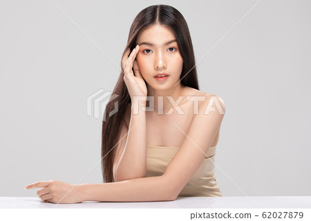 Beautiful Asian young woman touching soft cheek smile with clean and fresh skin Happiness and cheerful with positive emotional,isolated on white background,Beauty and Cosmetics Concept 62027879