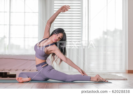 Asian woman practice yoga to meditation in bedroom 62028838
