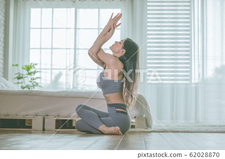 Asian woman practice yoga to meditation in bedroom Asian woman practice yoga to meditation in bedroom 62028870