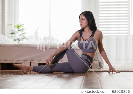 Asian woman practice yoga to meditation in bedroom Asian woman practice yoga to meditation in bedroom 62028896