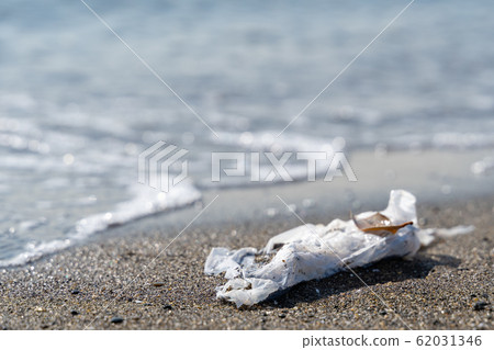 Shopping bag launched on a sandy beach marine garbage 62031346