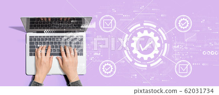 Quality control approval with person using laptop computer 62031734