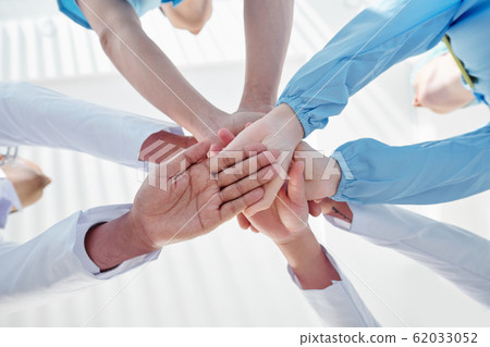 Medical workers stacking hands Medical workers stacking hands 62033052